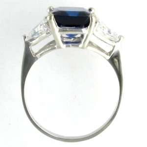  is a classic three stone ring with synthetic sapphire center stone 