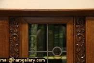   this bold china cabinet or bookcase has a leaded stained glass door